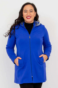 Front view of a woman wearing a cobalt blue hooded zip-up coat with hidden pockets