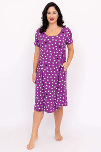Front view of a woman in a purple polka dot bamboo sleepshirt