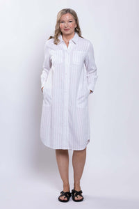 Front view of a woman in a white striped button-down shirt dress with pockets