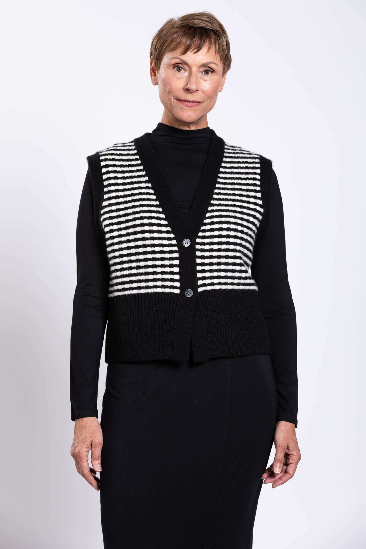Front view of a woman wearing a black and white striped wool-cashmere vest