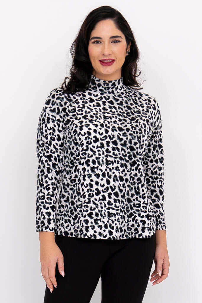 Front view of model wearing animal print Highdrop Top with mock neck and 3/4 sleeves