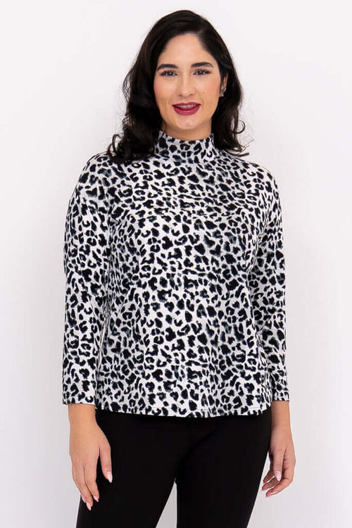 Front view of model wearing animal print Highdrop Top with mock neck and 3/4 sleeves