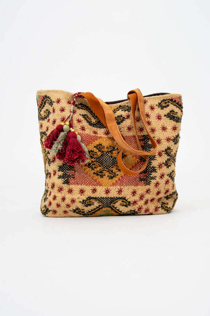 Front view of artisan tote bag with patterned cotton-jute shell and leather handle