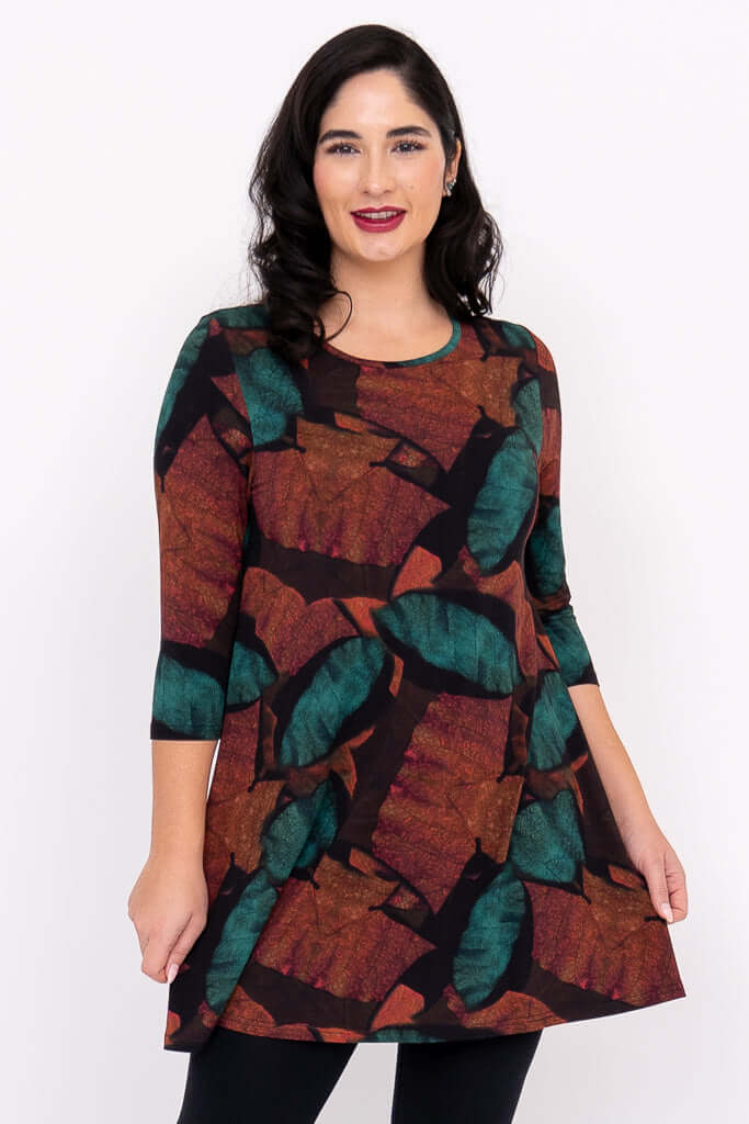 Woman wearing an autumn leaf print tunic top with 3/4 sleeves, front view