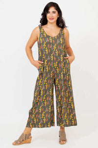 Front view of a woman wearing a sleeveless bamboo linen jumpsuit with floral print