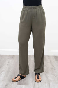 Front view of relaxed fit olive green bamboo linen pants on model