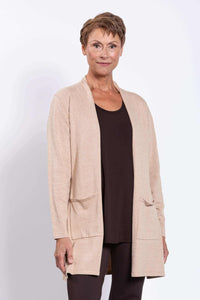 Front view of a woman wearing a beige open-front cardigan with patch pockets over a dark top