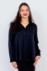 Front view of model wearing black Sylvie Blouse with long sleeves and button front