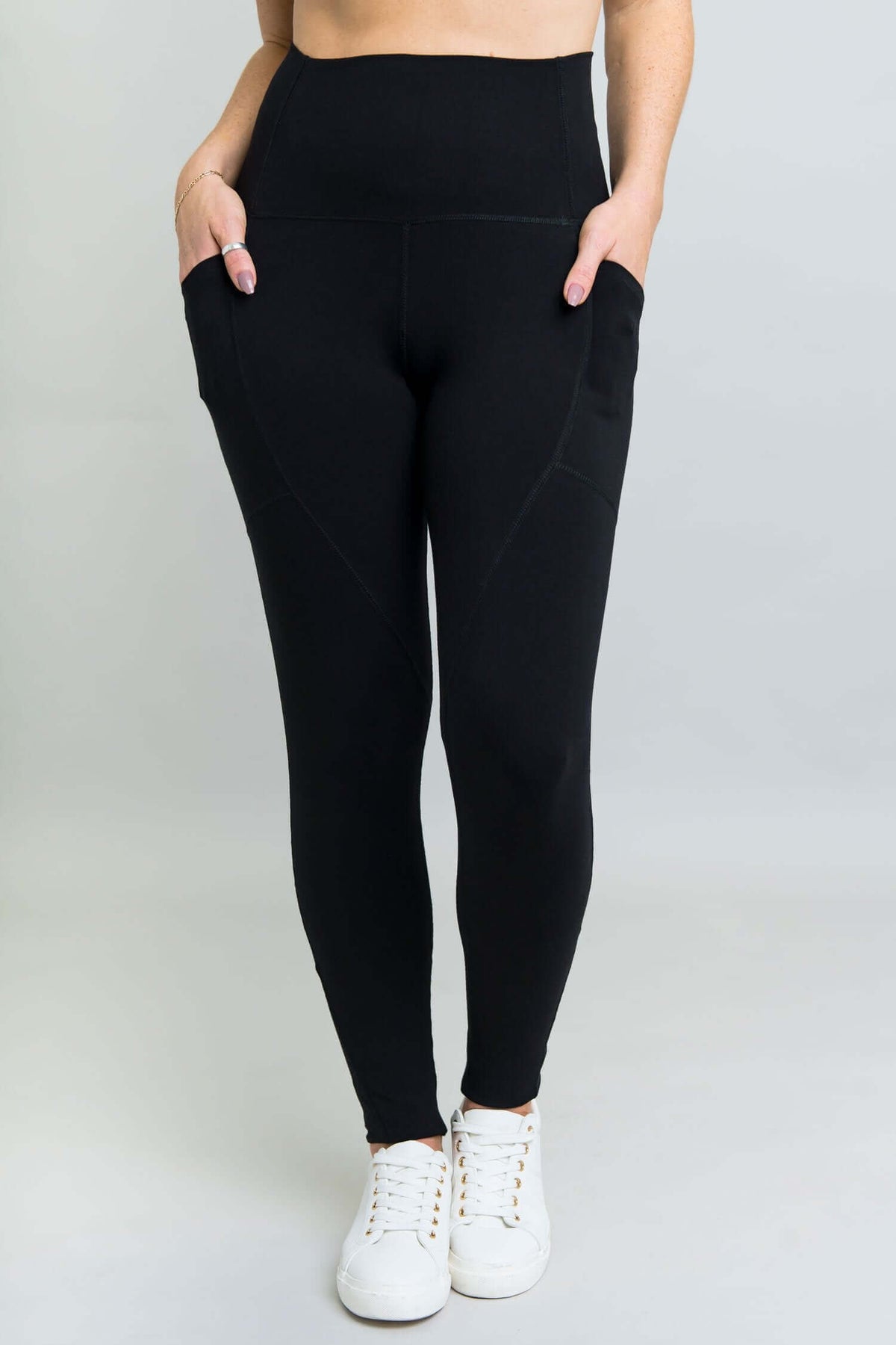 Front view of black fleece leggings with dual thigh pockets and wide waistband