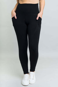 Front view of black fleece leggings with dual thigh pockets and wide waistband