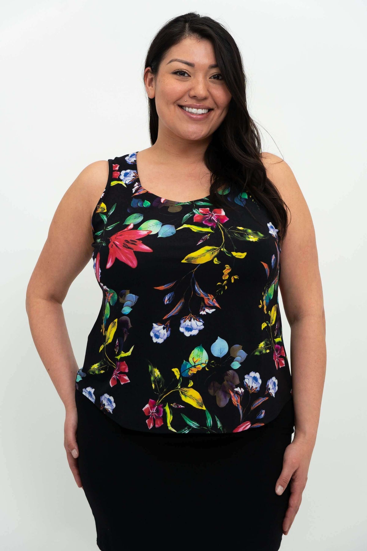 Front view of woman wearing a black tank top with vibrant floral print