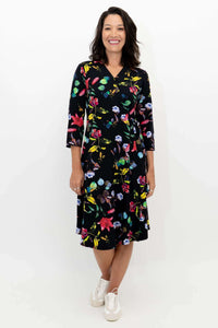 Front view of woman wearing a black floral wrap dress with three-quarter sleeves