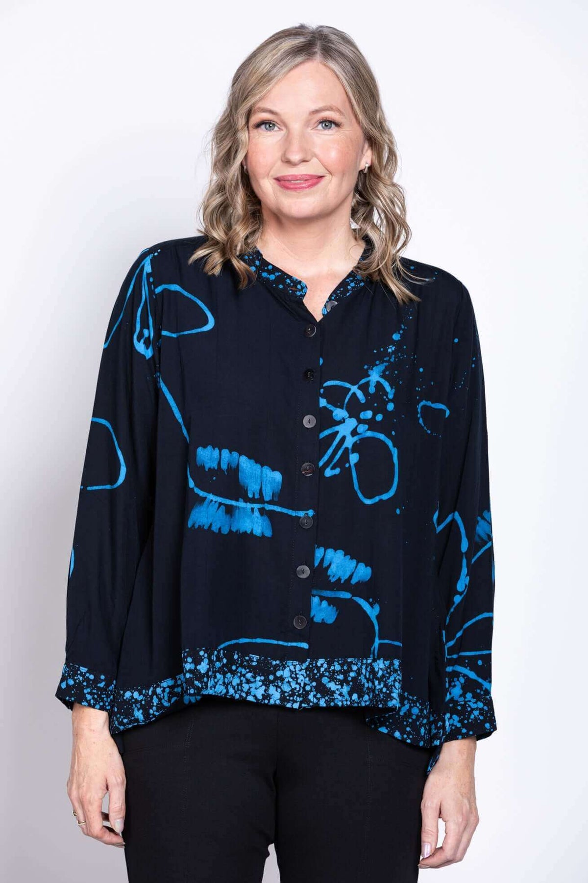 Front view of woman wearing blue Batik print blouse with mandarin collar