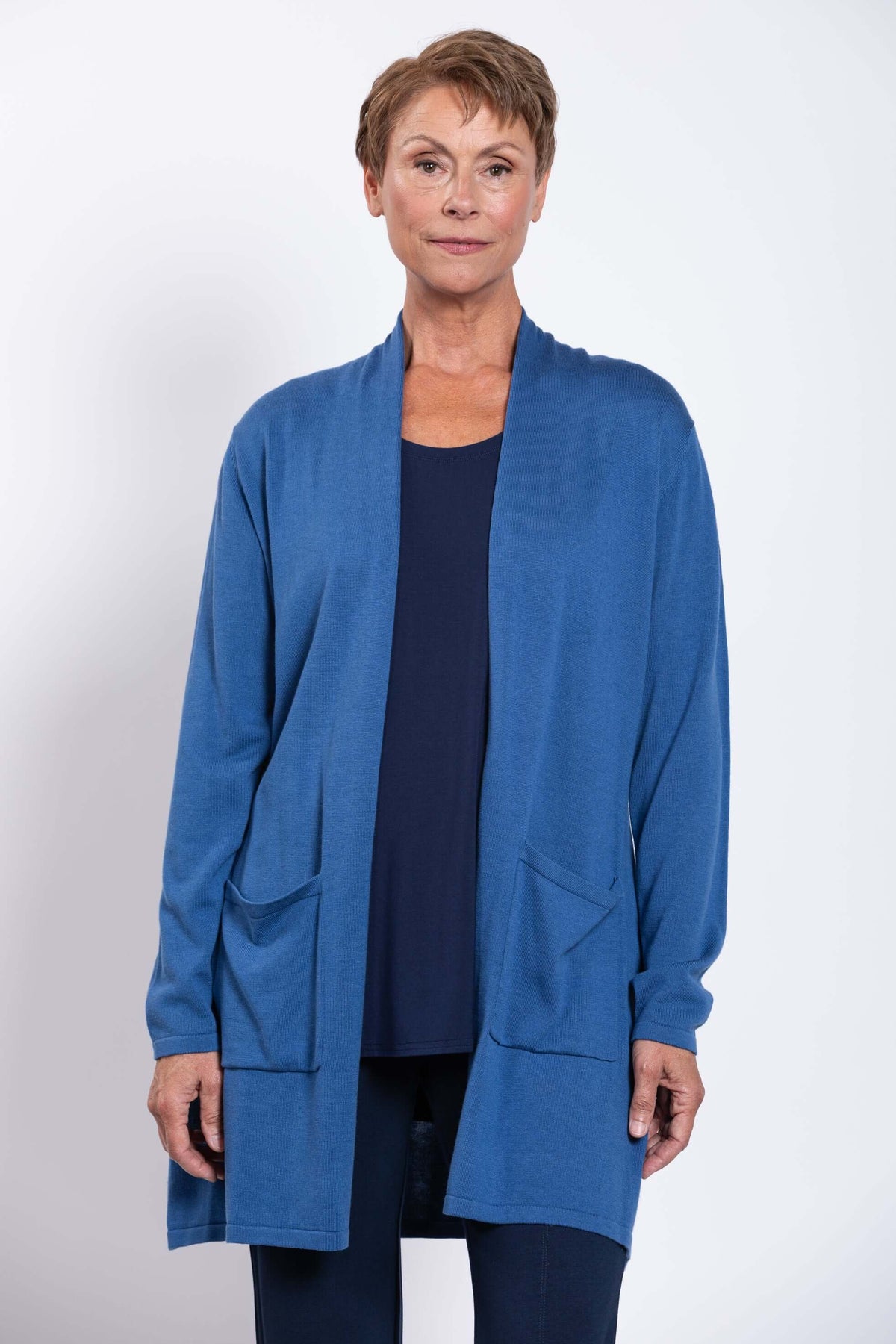 Front view of woman wearing blue Paige cardigan with patch pockets