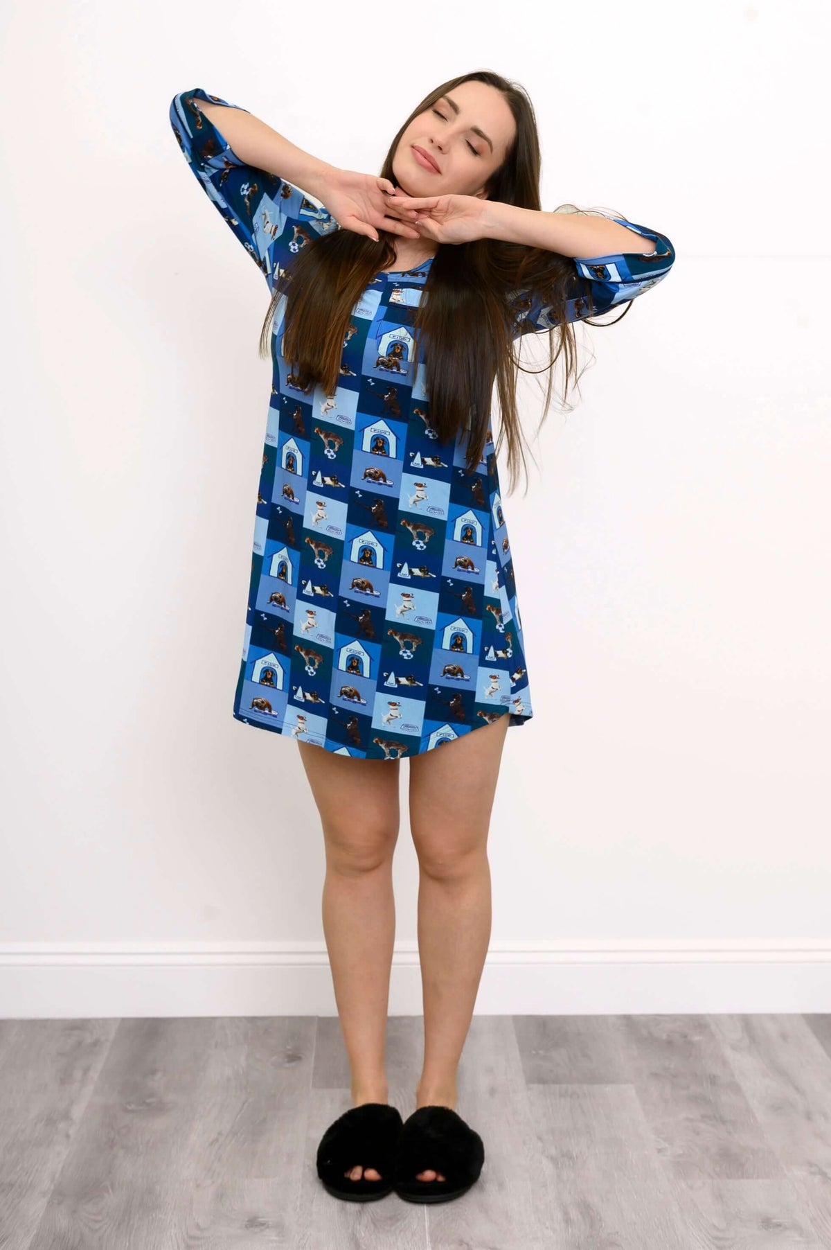Front view of model wearing blue bamboo sleepshirt with dog and doghouse print