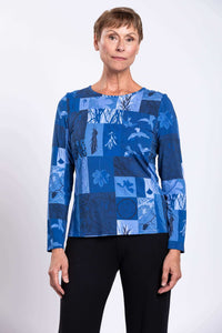 Woman wearing long sleeve blue botanical patchwork top front view
