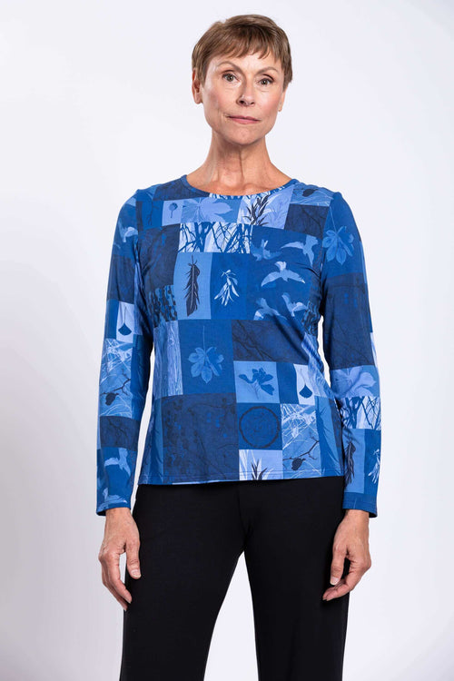 Woman wearing long sleeve blue botanical patchwork top front view