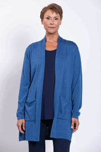 Front view of woman wearing a lightweight blue cardigan with patch pockets
