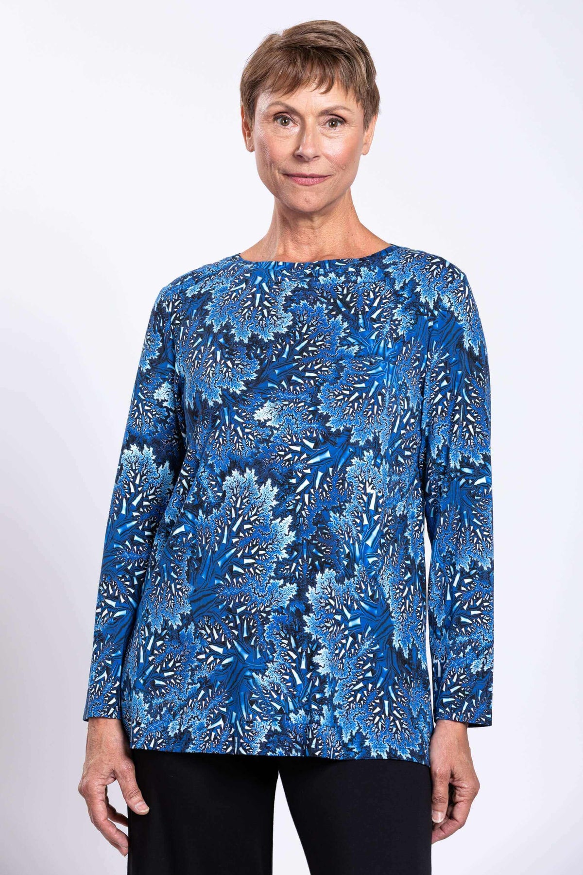 Front view of woman wearing blue coral print long-sleeve relaxed top