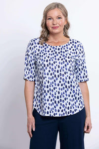 Front view of a woman wearing a blue dapple dot pattern blouse with elbow sleeves