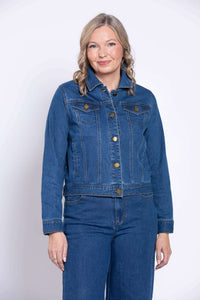 Smiling woman in blue denim jacket, front view, hands by sides