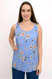 Front view of woman wearing a blue floral tank top with broad straps