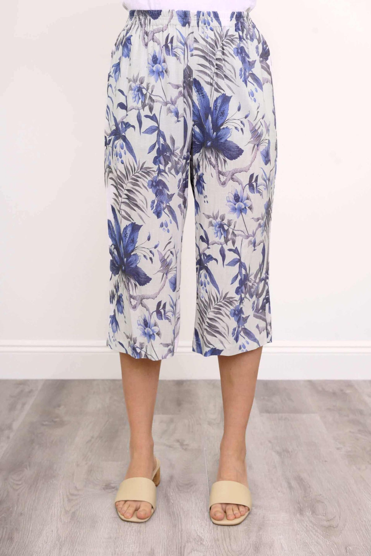 Front view of blue floral capri pants showing elastic waistband and floral pattern
