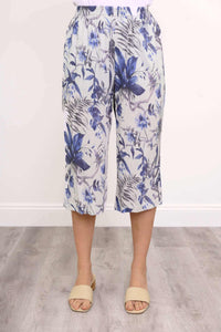 Front view of blue floral capri pants showing elastic waistband and floral pattern