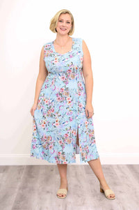 Front view of a woman in a blue floral sweetheart-neckline dress with floral pattern