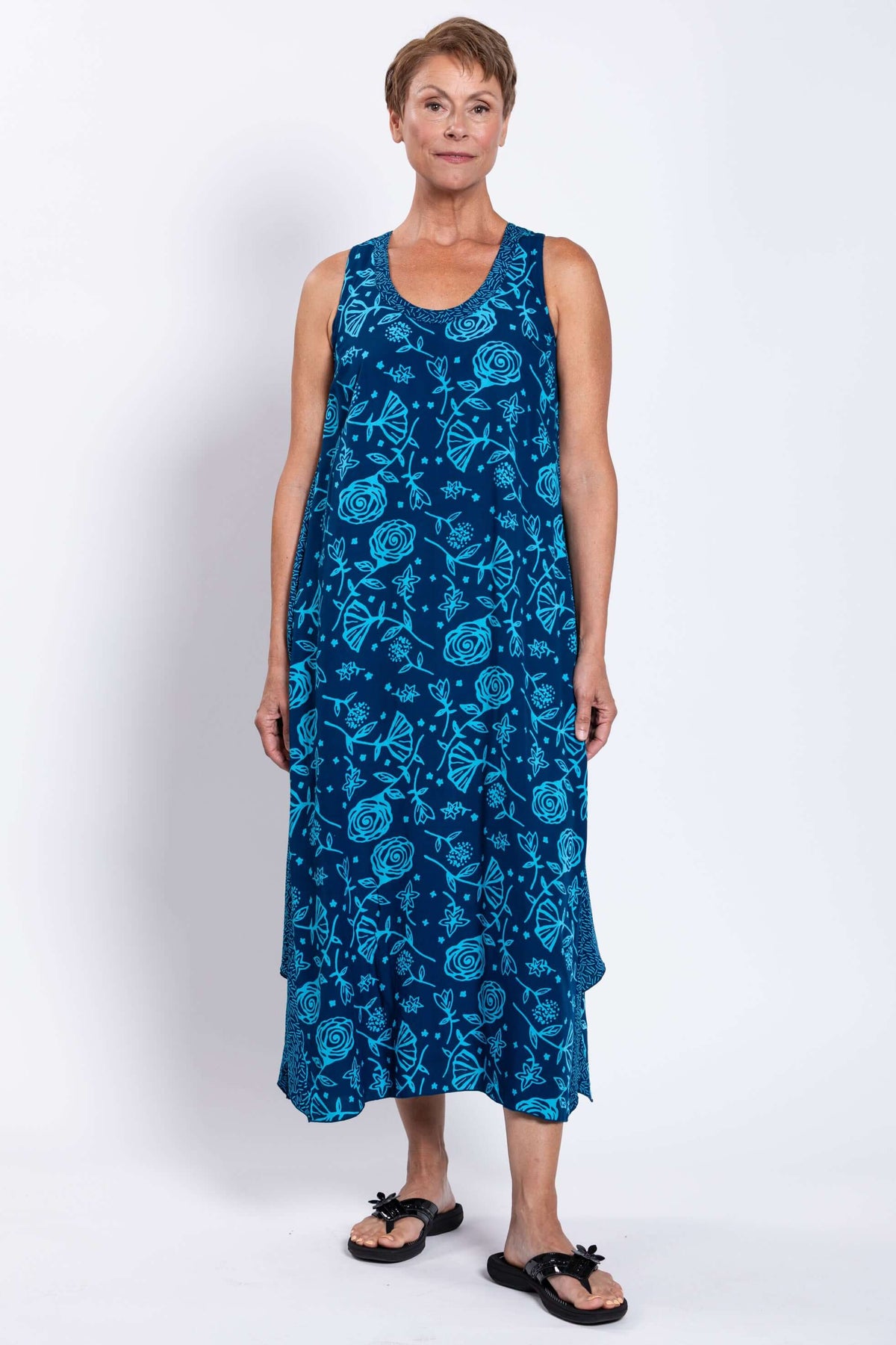 Woman modeling front view of the blue floral midi tank dress, hands by her side
