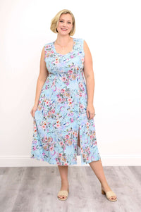 Front view of a woman in a sleeveless blue floral midi dress