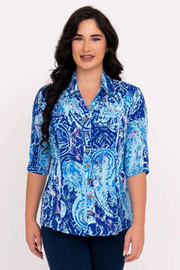 Front view of a woman wearing a blue mosaic print tailored blouse with elbow-length sleeves
