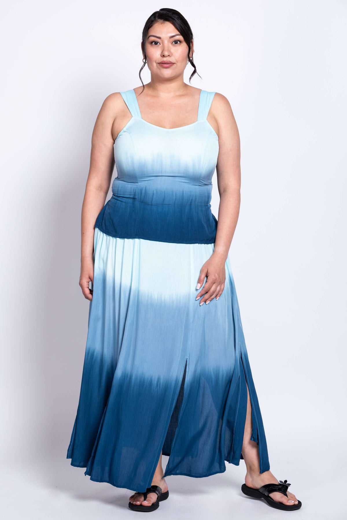 Front view of a model wearing a blue ombre maxi dress with wide straps and side slits