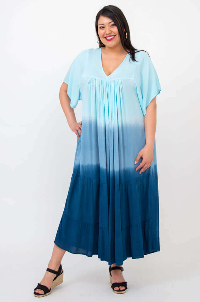 Front view of woman wearing a blue ombre tiered maxi dress with V-neck and short sleeves