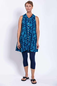 Front view of model in blue sleeveless floral tunic tank and navy leggings