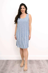 Woman wearing a blue striped sleeveless shift dress, smiling, front view