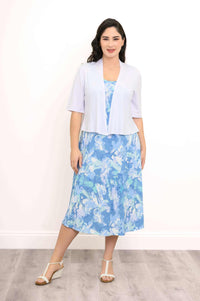 Woman wearing blue abstract tank dress with light cardigan, standing forward