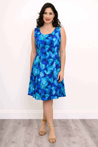 Front view of a woman wearing a sleeveless blue watercolor print dress with scoop neckline