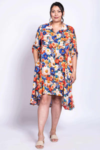 Front view of a plus-size model in a bright floral high-low ruffle dress