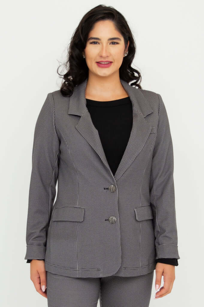 Front view of a woman wearing a tailored checkered blazer with matching trousers
