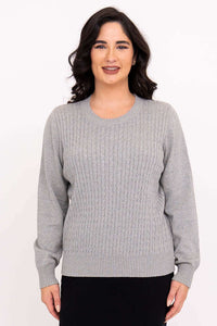 Front view of woman wearing classic grey cable knit sweater