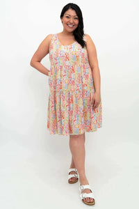 Front view of model wearing sleeveless colorful patterned tiered dress