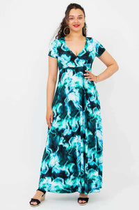 Front view of a woman in a teal marble print bamboo maxi dress with a crossover bodice and short sleeves