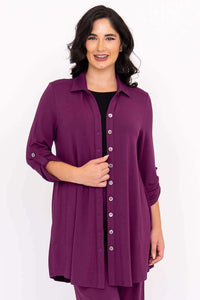 Front view of a woman with dark hair in a purple bamboo button-up tunic top