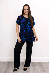 Woman in black top with midnight blue and purple floral design, front view
