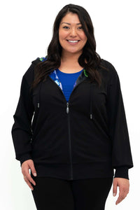 Front view of model wearing a black zip hoody with floral-print lining and blue top