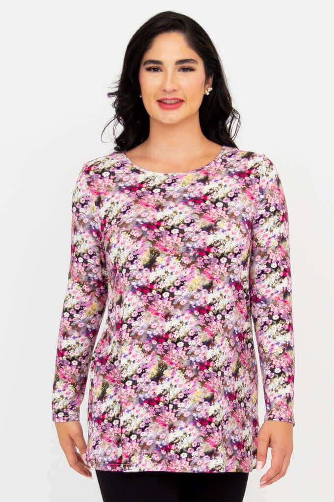 Front view of model wearing a long sleeve floral A-line tunic top