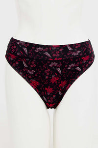 Front view of a floral bamboo thong in black and red on mannequin