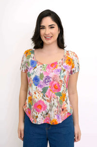 Front view of woman wearing a floral print sweetheart neckline short sleeve top