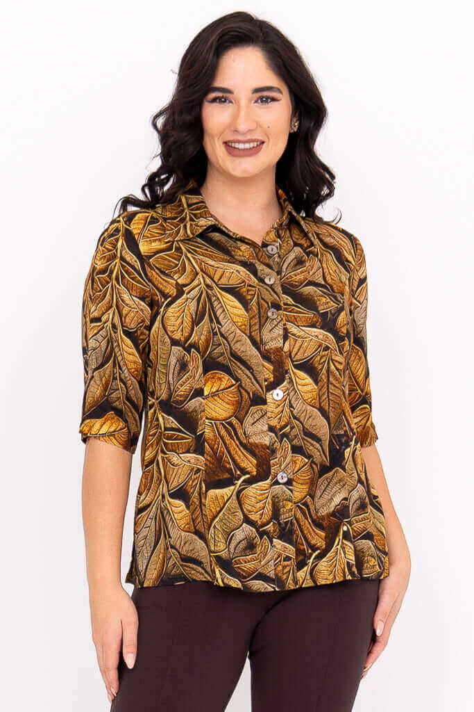 Woman wearing a button-up bamboo-linen blouse with bold leaf print, front view